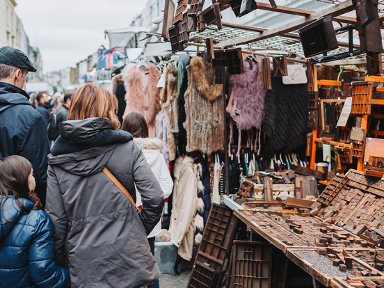 People looking at a stand on Portobello Road