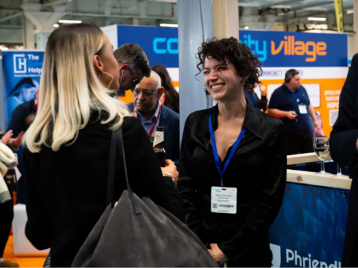 Two people conversing at a trade show.