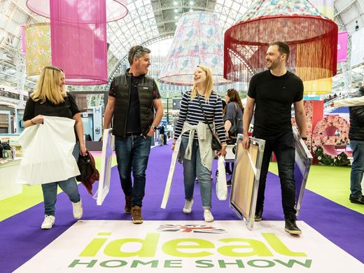 Four individuals smiling and laughing as they shop.