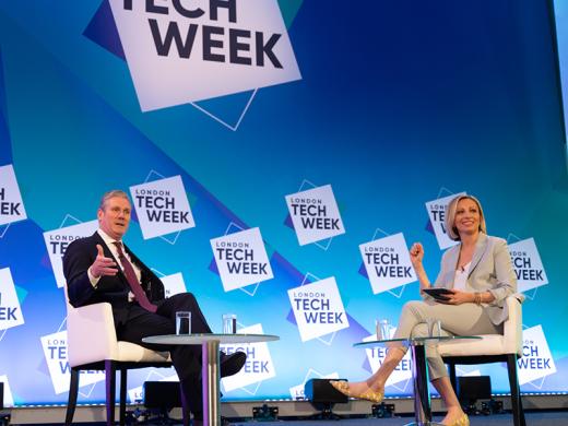 The UK prime minister and a woman talking on stage.