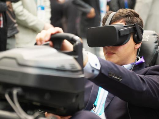 A man in a suit is immersed in a virtual reality experience while wearing a VR headset.
