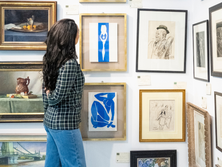 Woman admiring art on the wall.