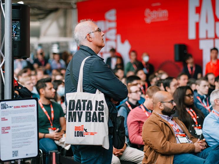 A person holding a bag with the words "data is my bag" at the conference.