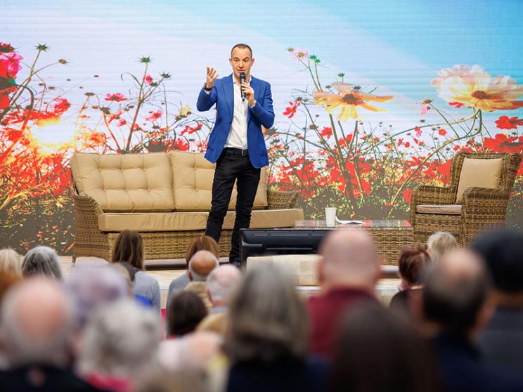 Martin Lewis presenting on stage.