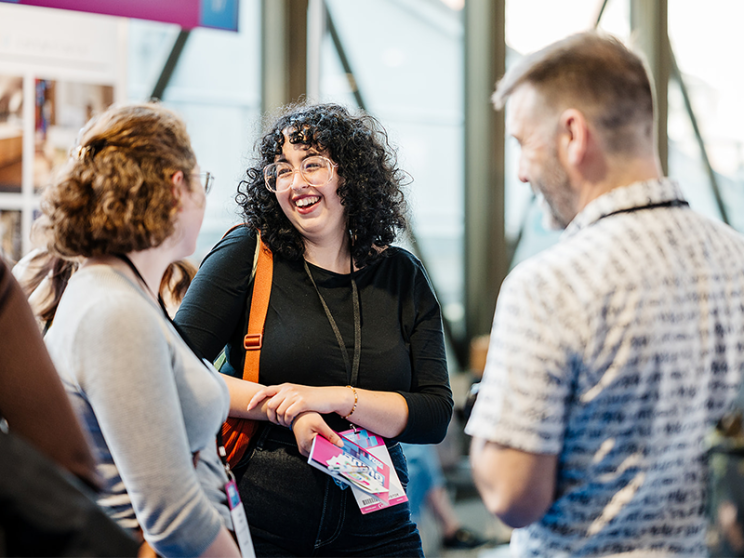 A gathering of people conversing at an event.