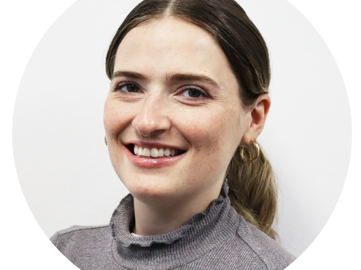 Headshot of a woman smiling to the camera.