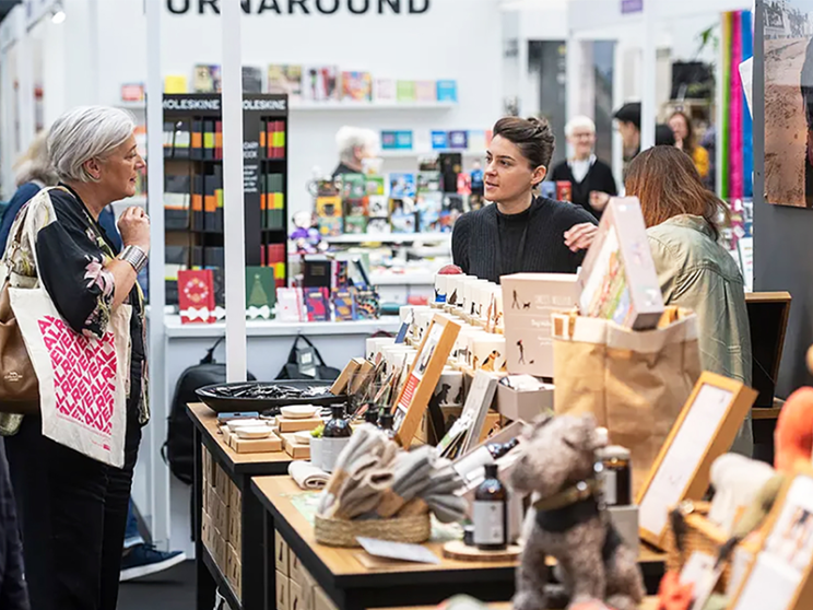 Two woman looking at a display of items at Top Drawer