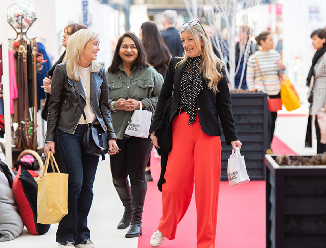 Three women walking beside each other through spirit of Christmas 