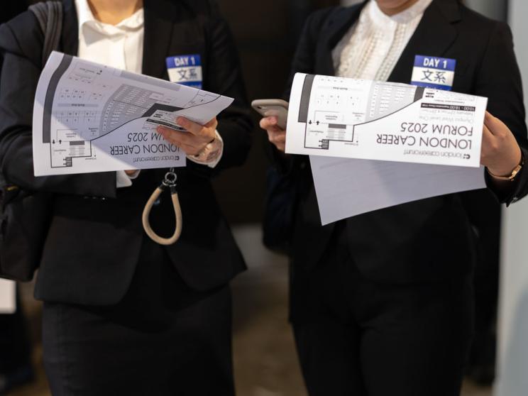 Two people engaging in paper forms 