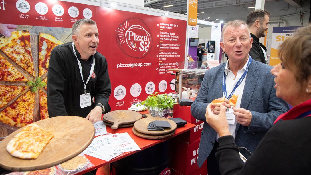 Exhibitor talking to a visitor about their food service offering