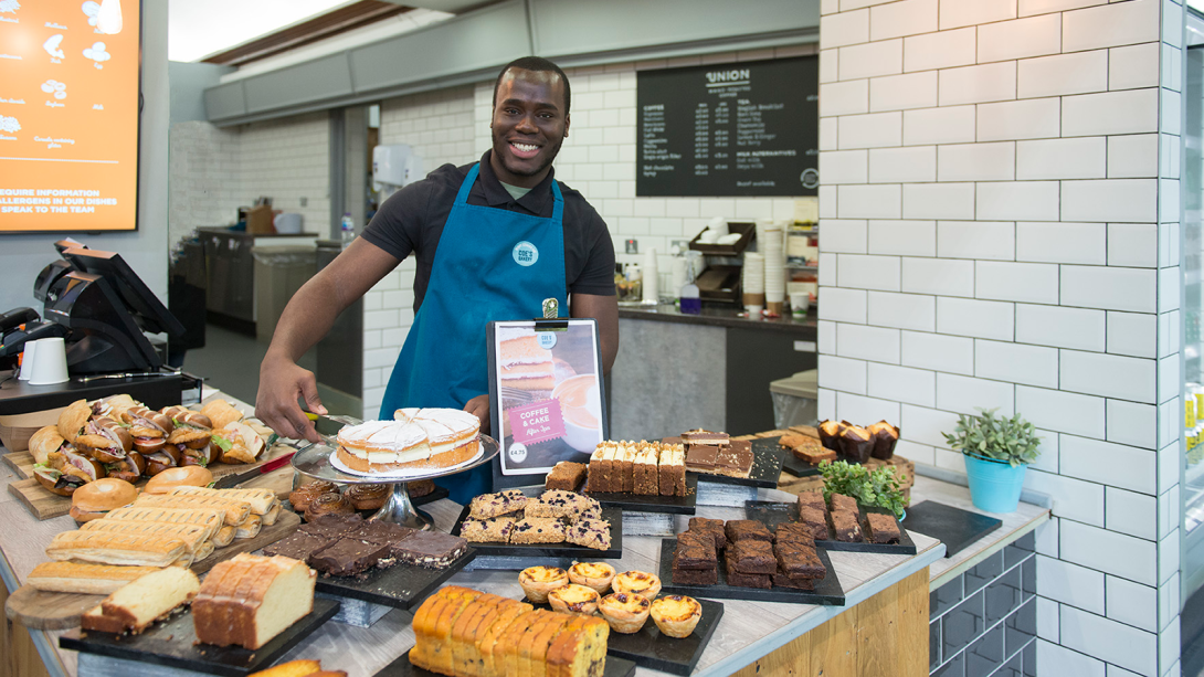 Man serving behind the counter at Coe's Bakery