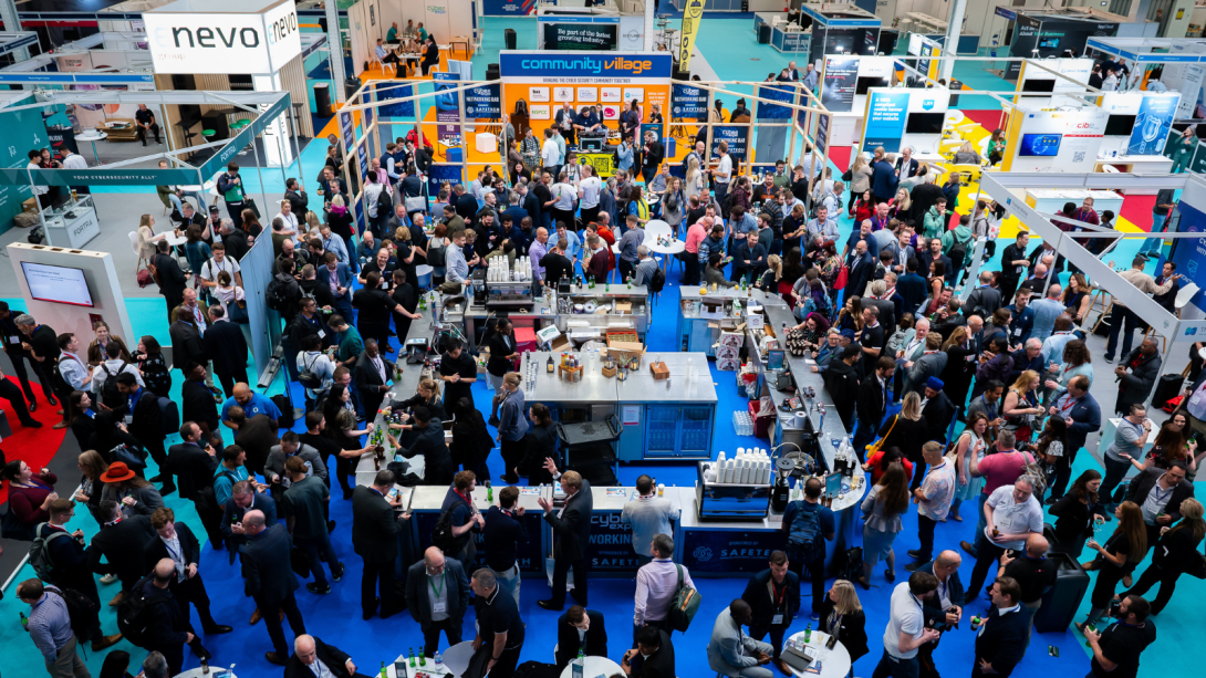 A group of people gathered at an exhibition, looking at various displays and engaging with each other.