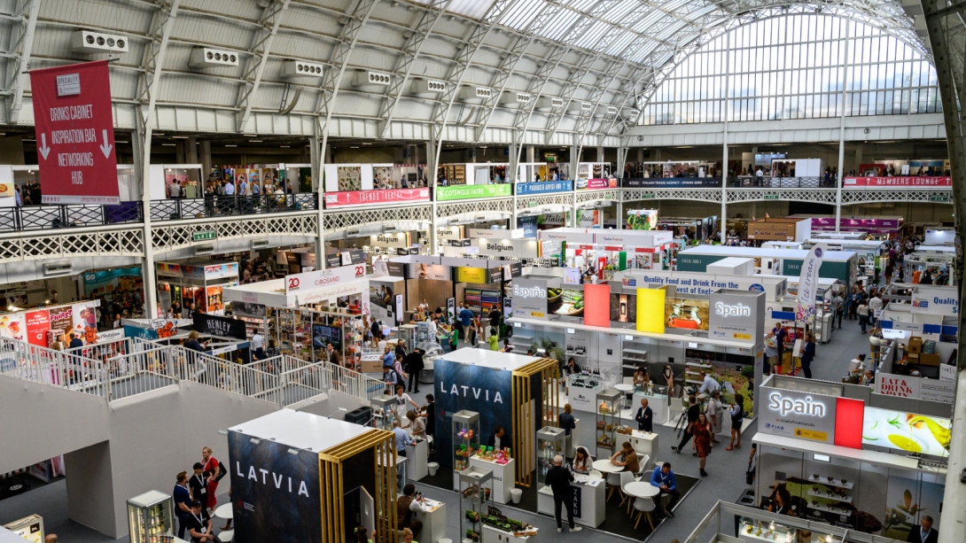 An indoor market filled with a variety of goods and shoppers exploring the different offerings.