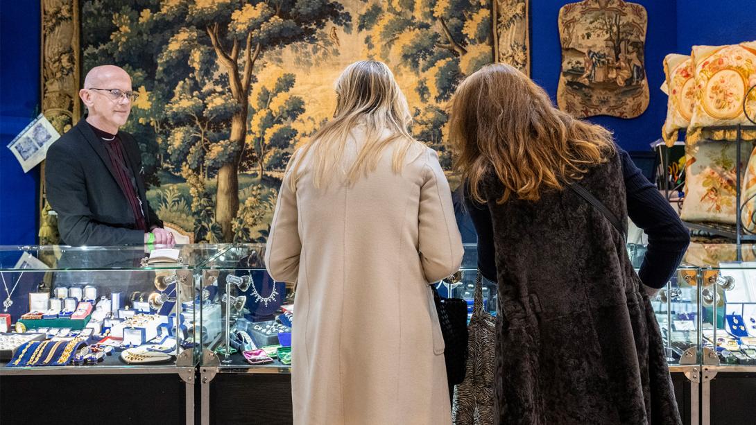 Two women examining jewellery in a store, captivated by the sparkling gems and intricate designs.