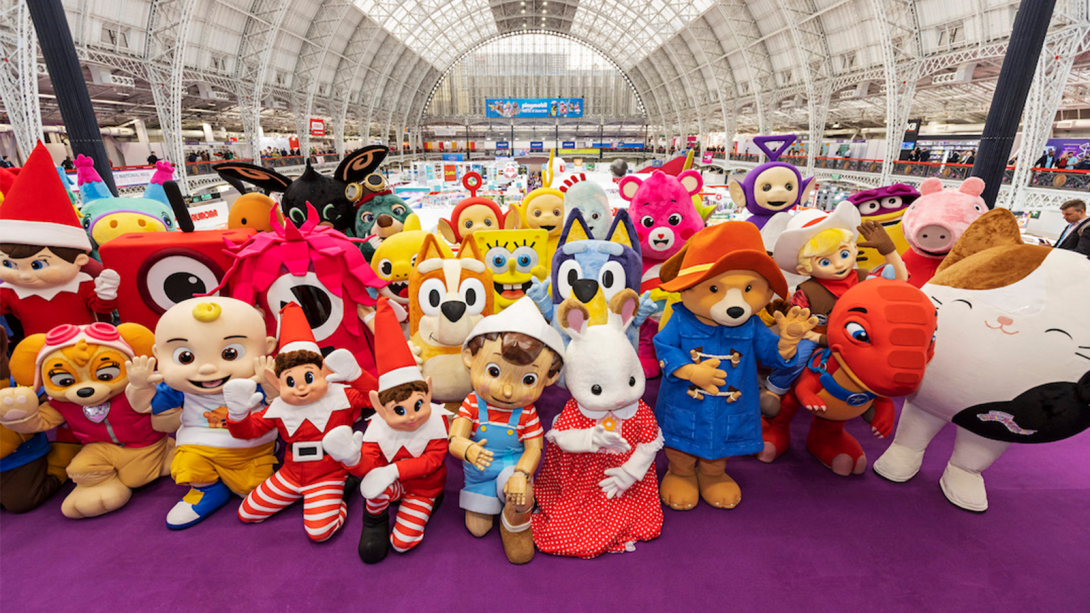 A collection of various stuffed animals gathered closely, all appearing joyful as they pose together for a group photo.