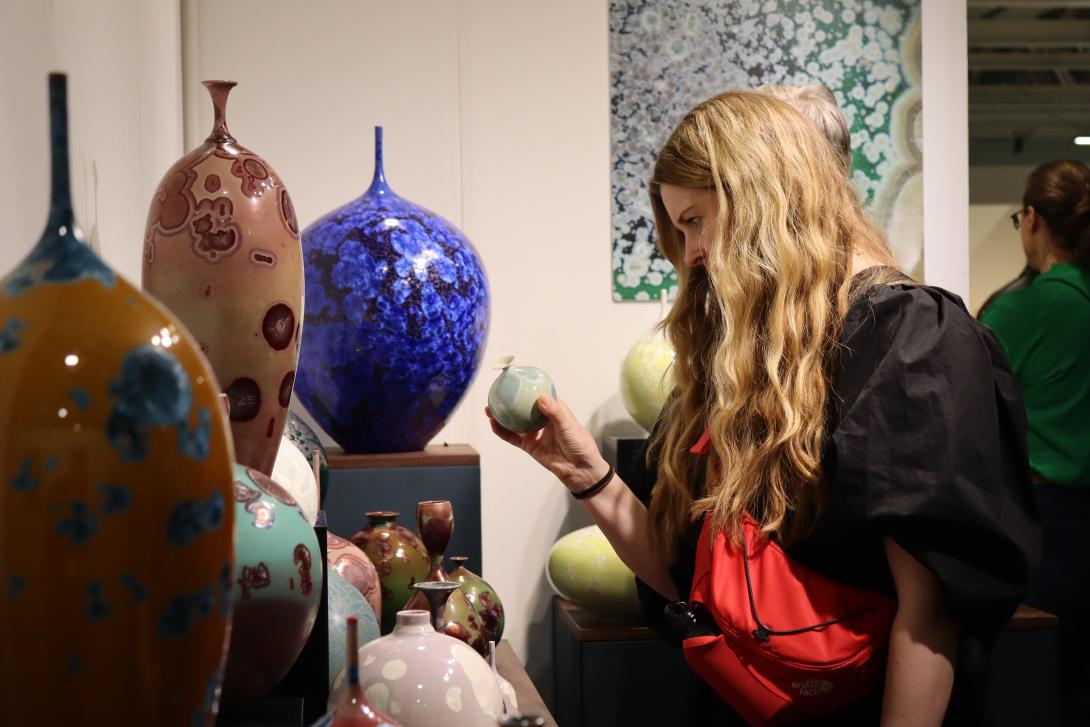 A woman looks at ceramic art