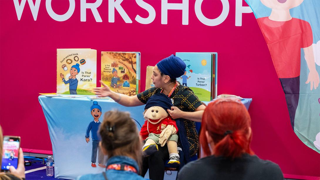 A woman engages with children while holding a doll, fostering a playful and interactive atmosphere.