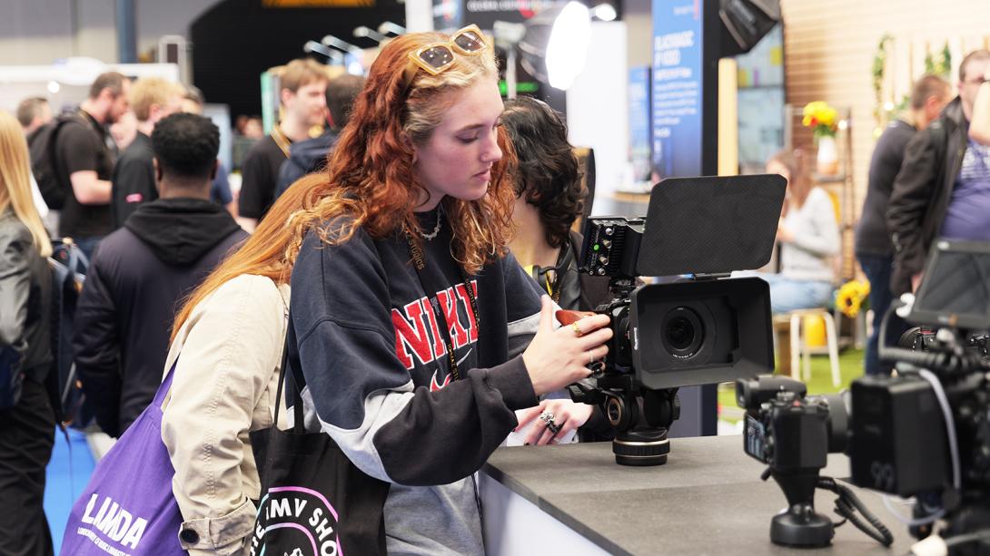 A woman gazes at the camera while attending a trade show, showcasing her engagement with the event.