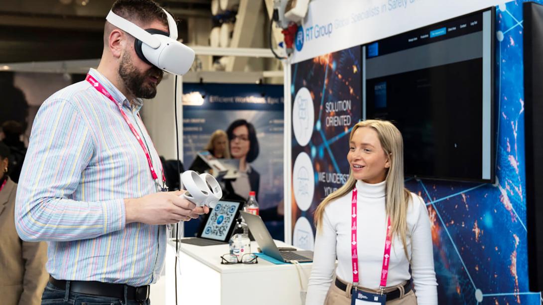 A man and woman stand side by side, engaged in a virtual reality demonstration.