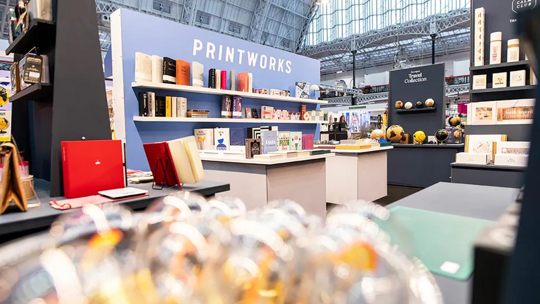 A vibrant booth with numerous books and assorted items, inviting customers to discover and enjoy their offerings.