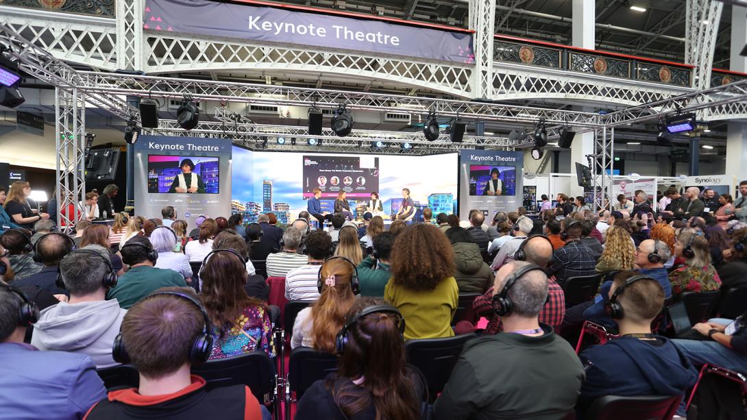 A large crowd of people gathered in a spacious room, engaged in conversation and activities.