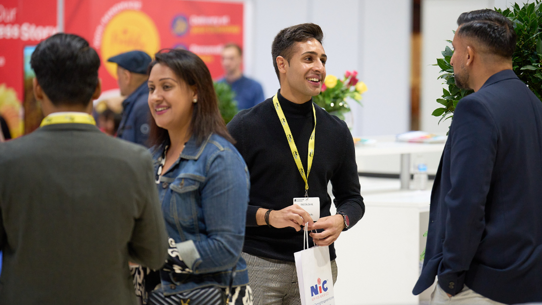 Attendees interacting and discussing ideas at an event.