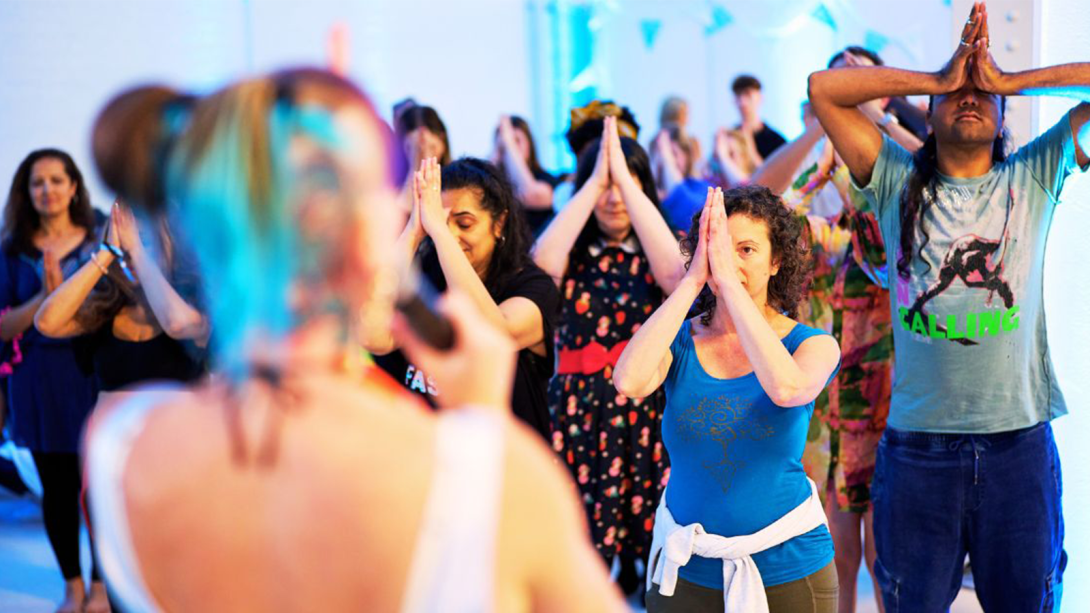 A group of people participating in a workshop during the Mind, Body, Spirit Festival 