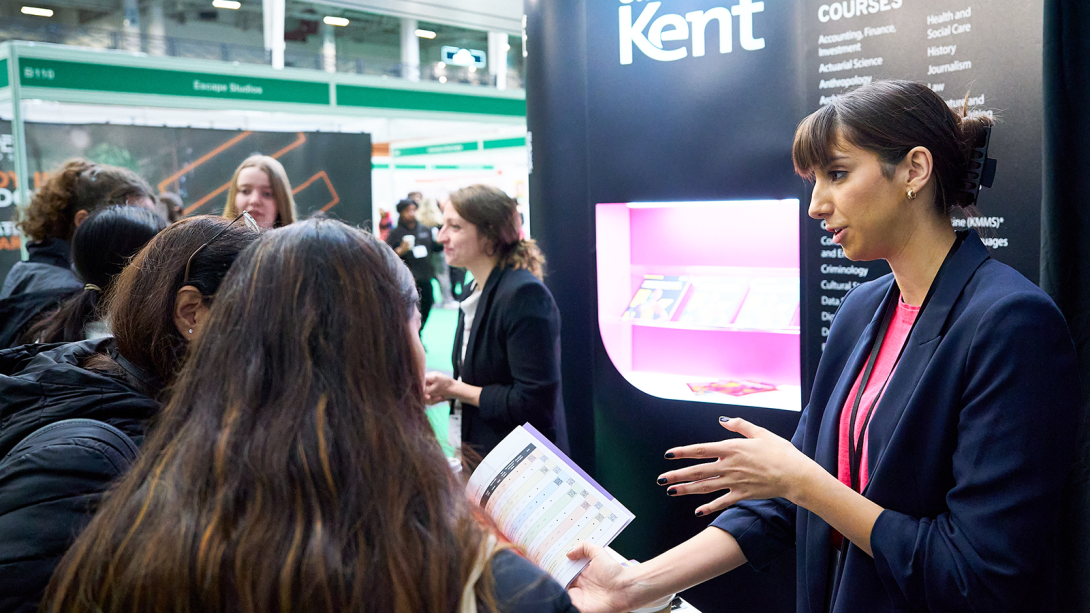 An exhibitor discussing with pupils potential career opportunities 