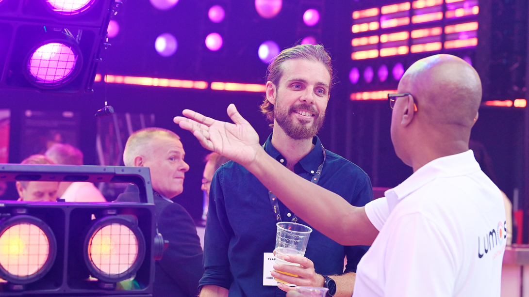 Two men discussing the exhibitor showcase at PLASA 