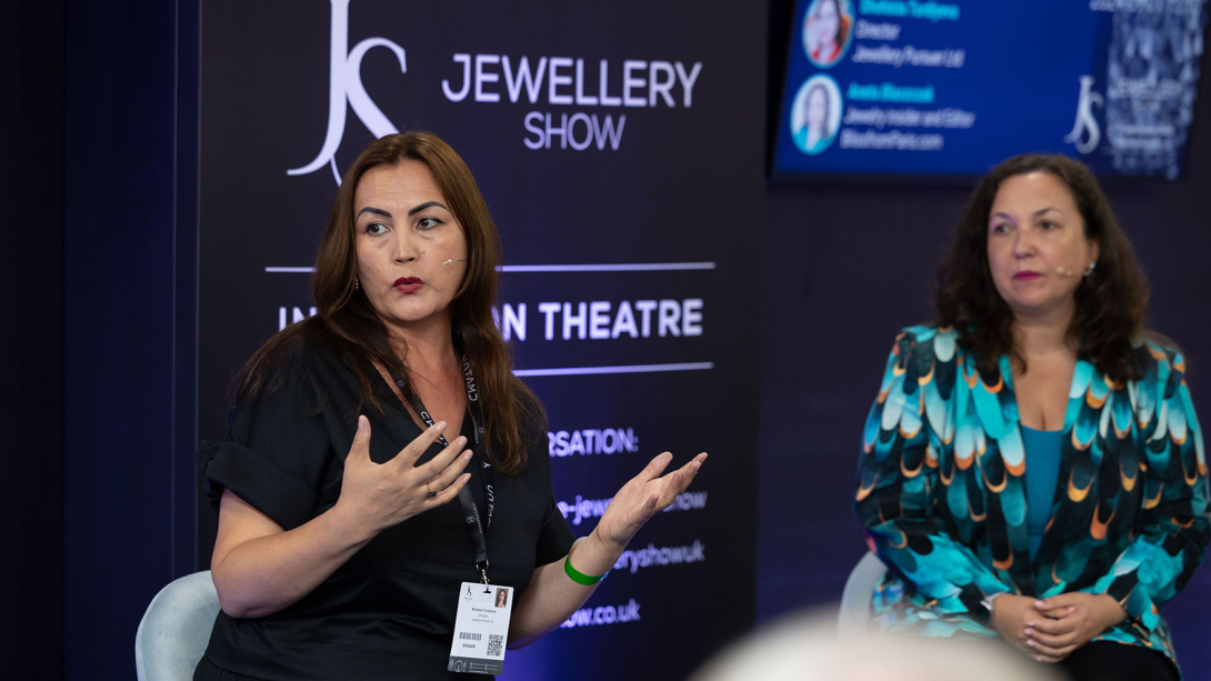 Two women on stage presenting at The Jewellery Show 