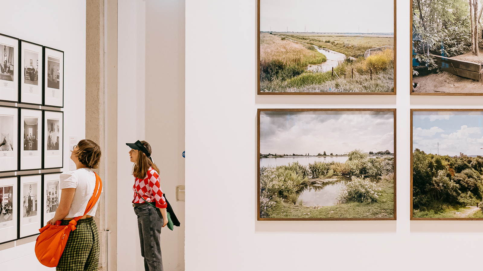 Visitors engaged in various photography pieces at Photo London