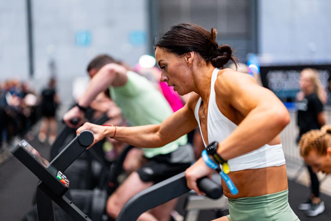 A woman on a fitness machine competing at Hybrid Games
